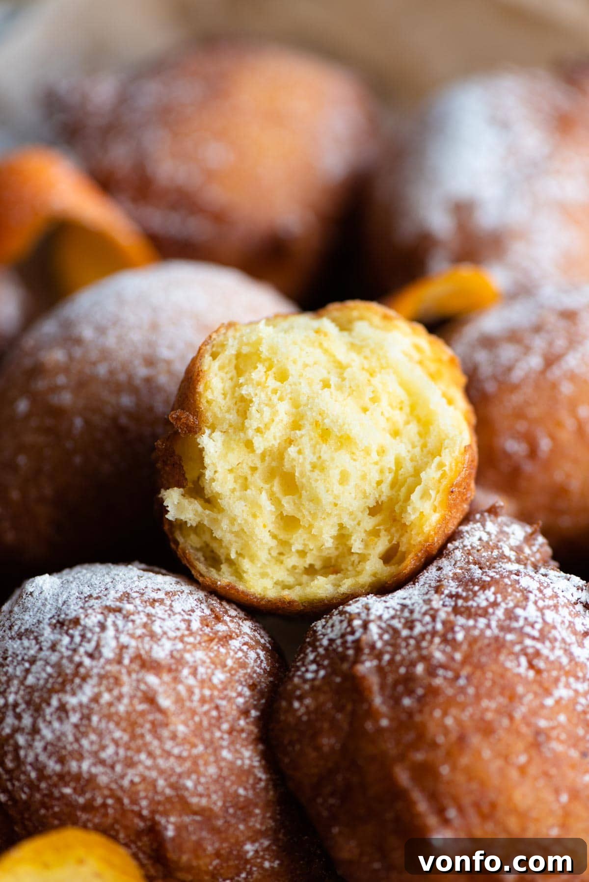 Pillowy Italian Ricotta Donuts 6 A close-up shot of an Italian ricotta doughnut cut in half, revealing its incredibly soft, airy interior and the delicious texture.