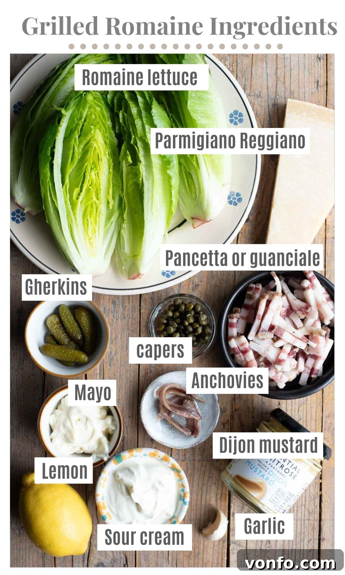 Fire-Kissed Romaine with Zesty Caper Dressing 3 An overhead shot showcasing all the essential ingredients laid out for preparing the grilled romaine salad, including fresh romaine lettuce, a bowl of creamy caper dressing, cubed pancetta, and a block of Parmigiano Reggiano cheese.
