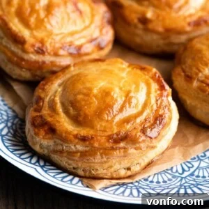 A close-up of a single Rustico Leccese on a blue plate, showing its flaky, golden crust.