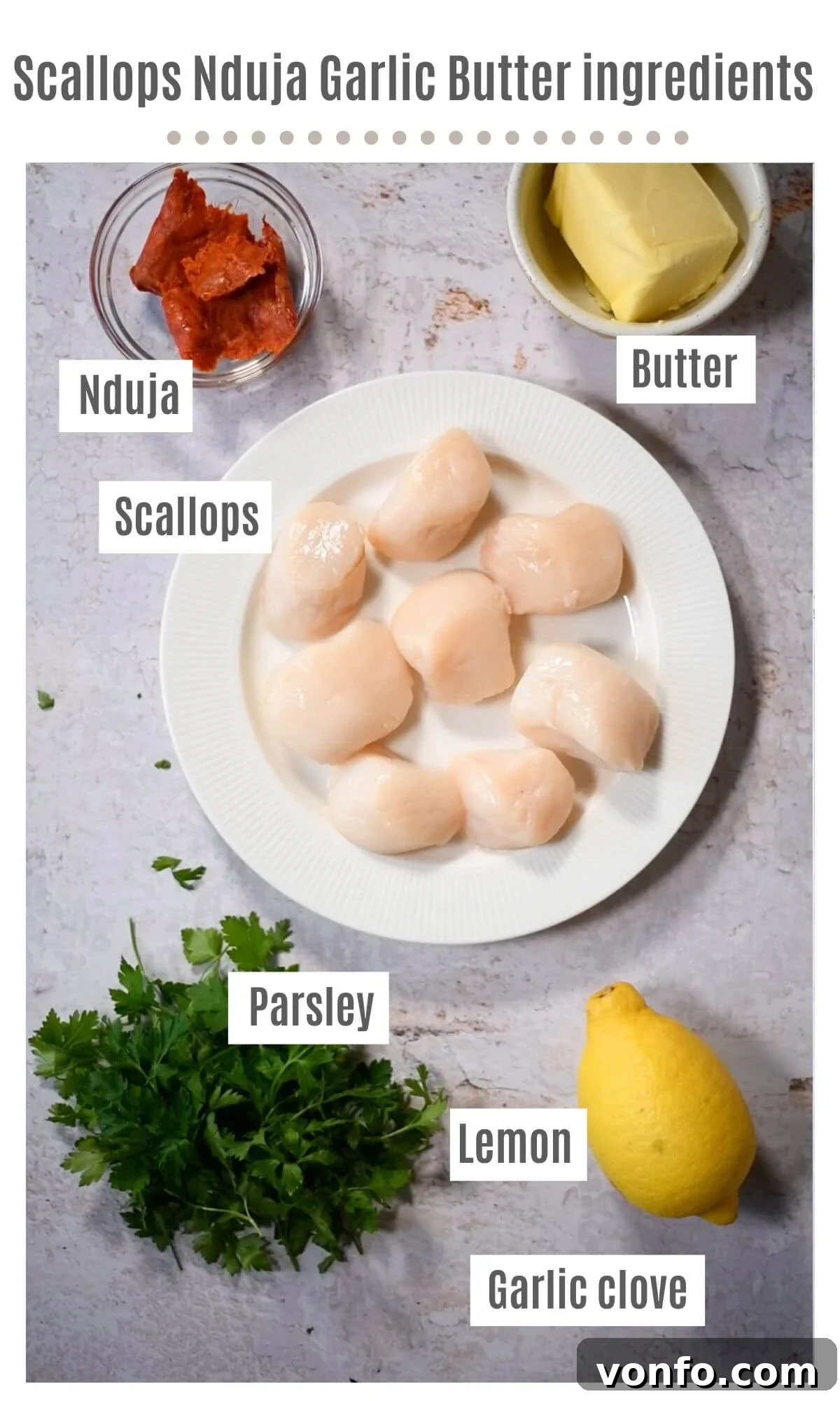 'Nduja Garlic Butter Scallops 3 An overhead shot showcasing all the essential ingredients laid out for making Scallops with 'Nduja Garlic Butter: fresh scallops, 'Nduja, butter, garlic, parsley, and lemons.
