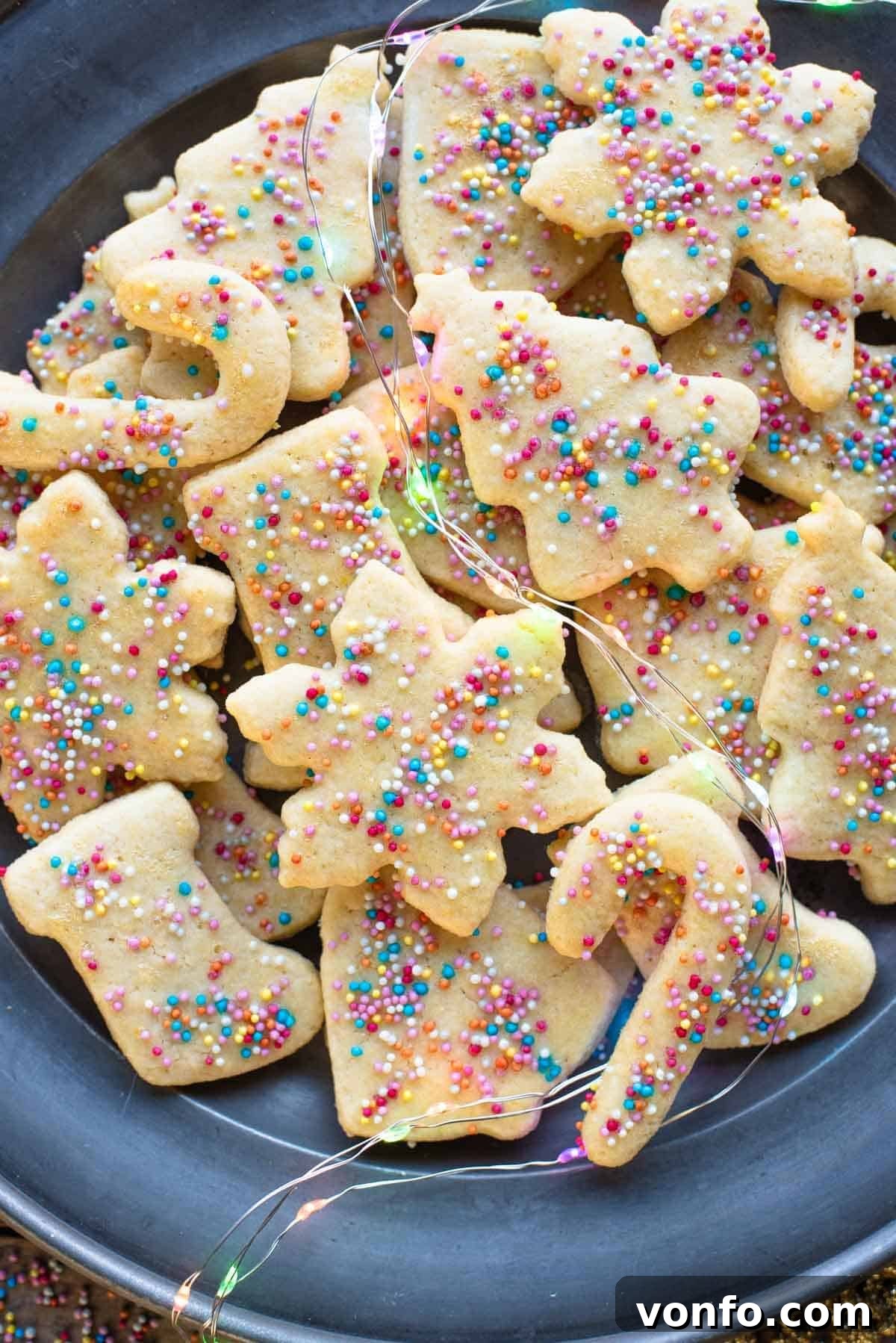 Befanini Authentic Tuscan Christmas Delights 7 A close-up shot of perfectly baked Befanini Christmas cookies, adorned with colorful sprinkles, artfully arranged on a plate, ready to be enjoyed.