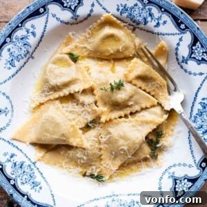 A cropped image of delicate Triangoli pasta in a blue patterned bowl, highlighting the dish's appeal and texture.