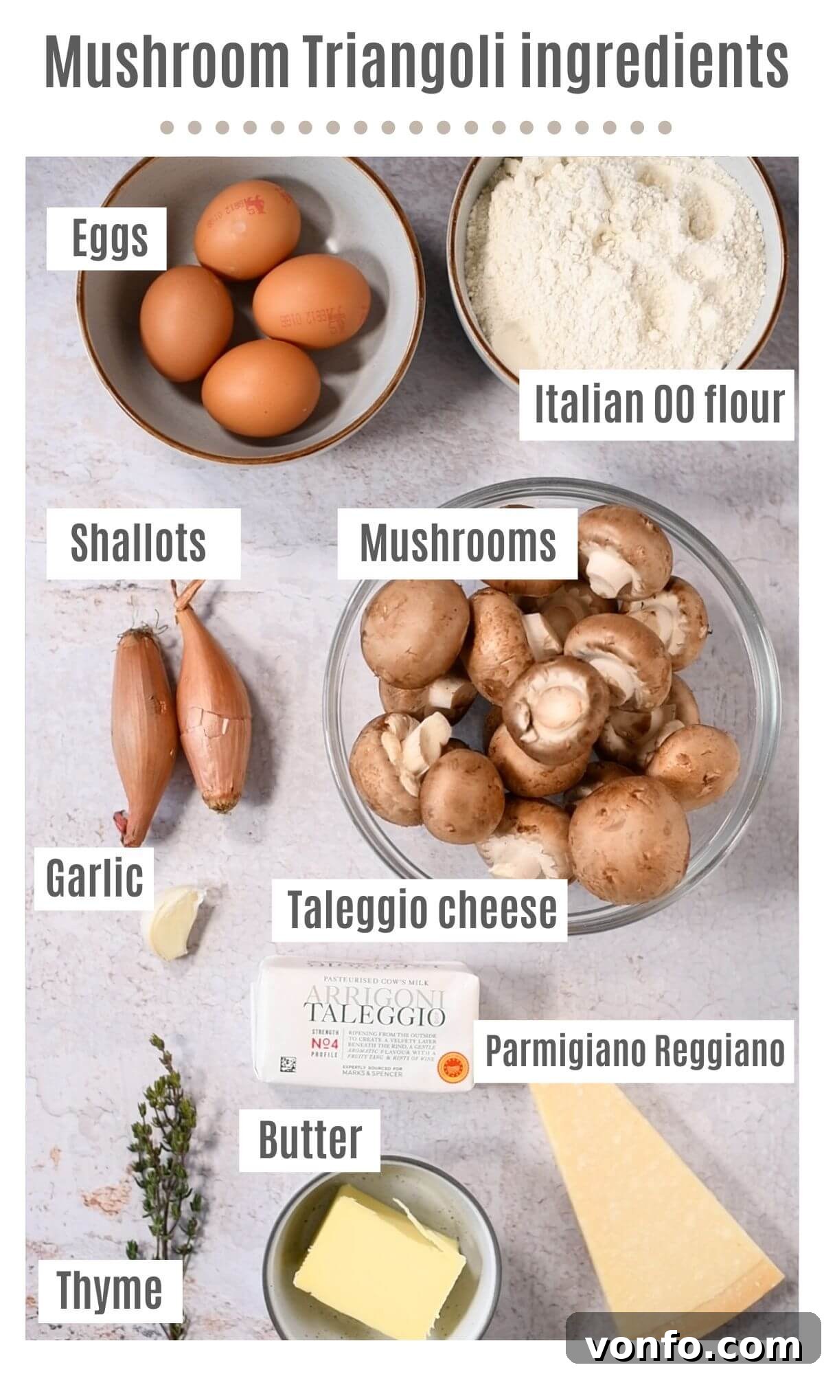 An overhead shot of all the fresh ingredients perfectly laid out, including Italian 00 flour, golden-yolk eggs, crimini mushrooms, creamy Taleggio cheese, and fresh thyme, essential for homemade Triangoli pasta.