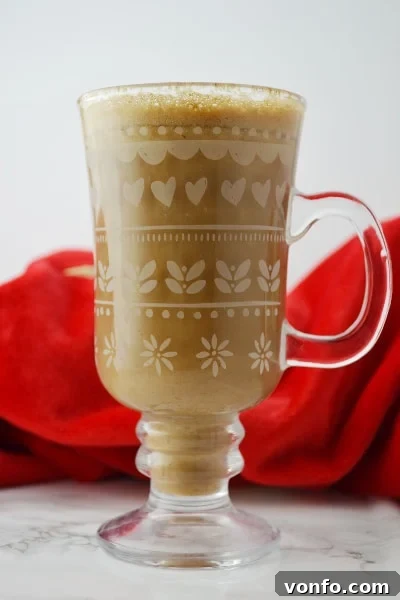 Creamy Banana Milk Coffee - Perfect for Chilly Days Banana milk coffee gracefully poured into a glass mug, resting on a pristine white surface, ready to be enjoyed.