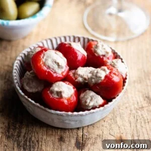 A close up of tuna stuffed cherry peppers in a small dish.