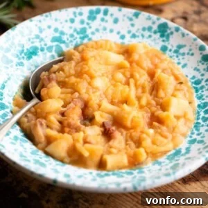 A cropped image of Pasta e Patate in a blue speckled bowl, illustrating the final dish.