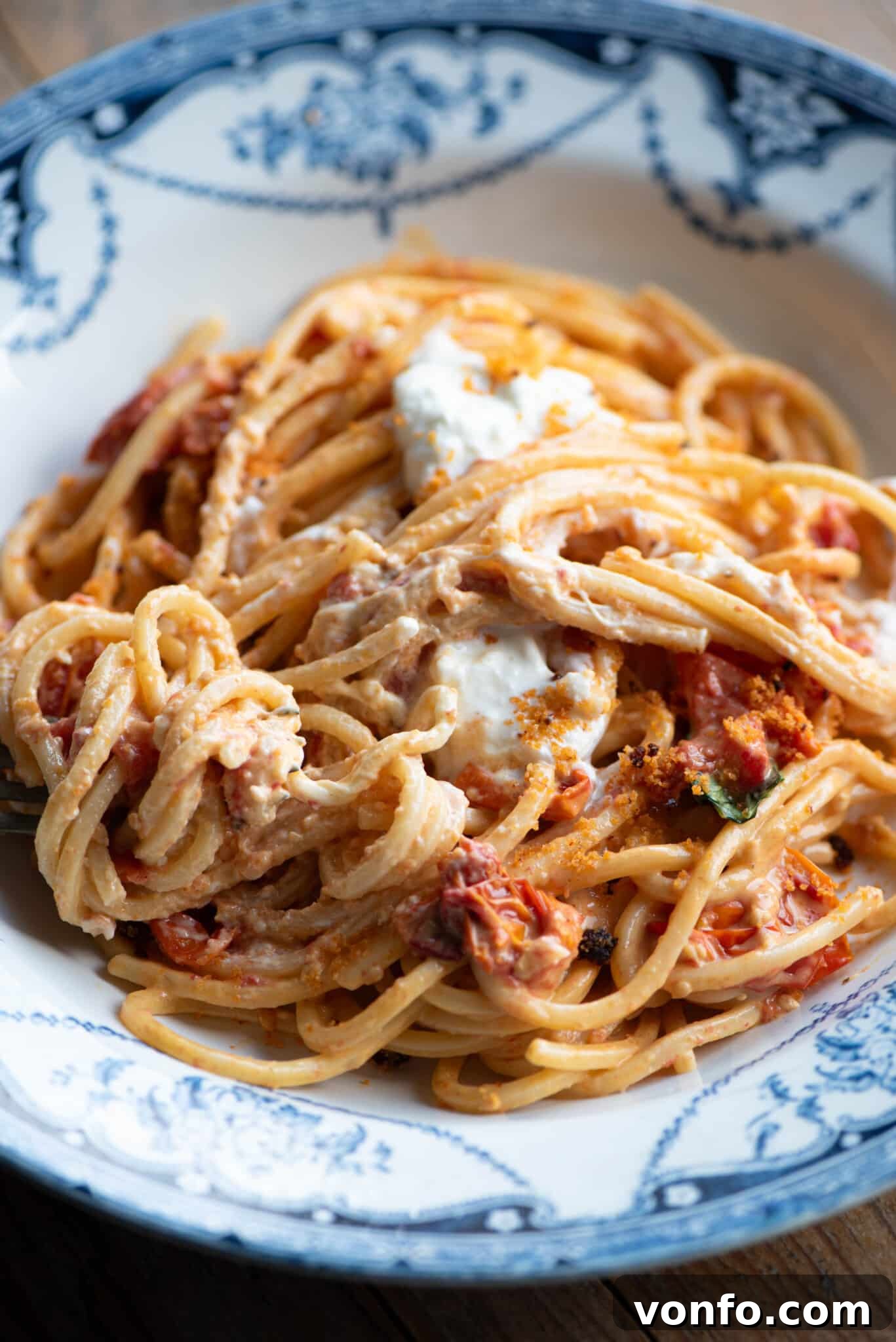 Burst Cherry Tomato Pasta with Fiery Nduja and Creamy Burrata 7 A close-up shot of roasted cherry tomato spaghetti, adorned with creamy burrata and crispy 'Nduja breadcrumbs, ready to be enjoyed.