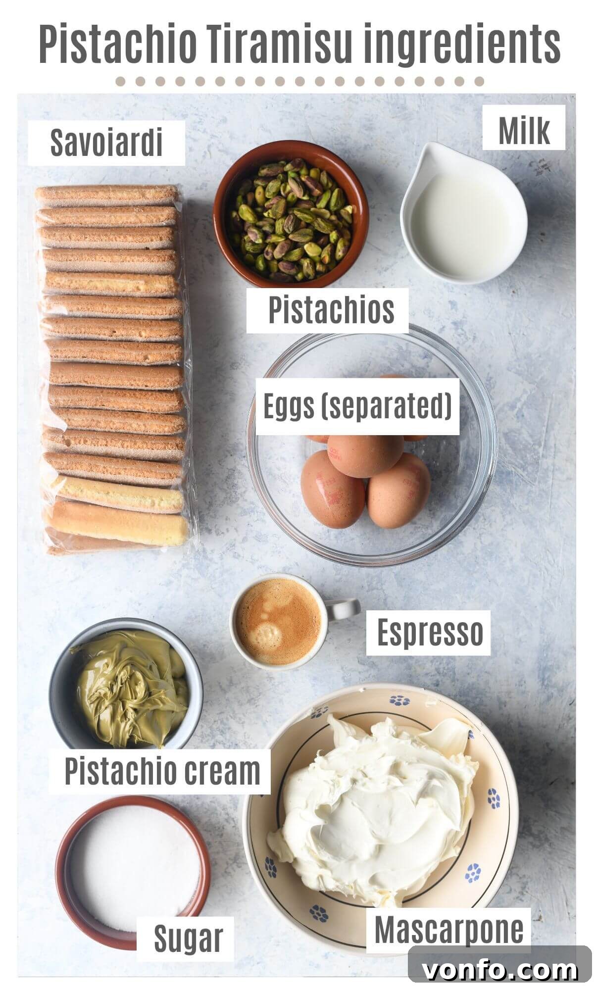 Green Gold Tiramisu 3 An overhead shot of all the ingredients needed to make Pistachio Tiramisu, including eggs, mascarpone, pistachio cream, coffee, milk, and Savoiardi biscuits.