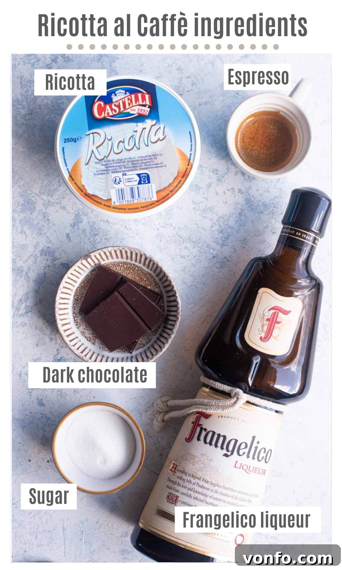 Coffee Ricotta 3 An overhead shot showcasing all the essential ingredients laid out for making Ricotta al Caffè: a tub of ricotta, a small cup of espresso, sugar, a bottle of Frangelico liqueur, and a bar of dark chocolate.