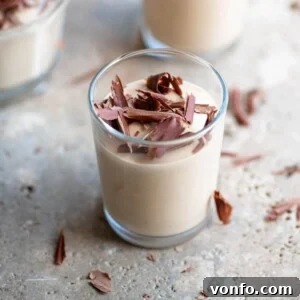 A close up of creamy coffee ricotta dessert (Ricotta al Caffè) in a small serving glass.