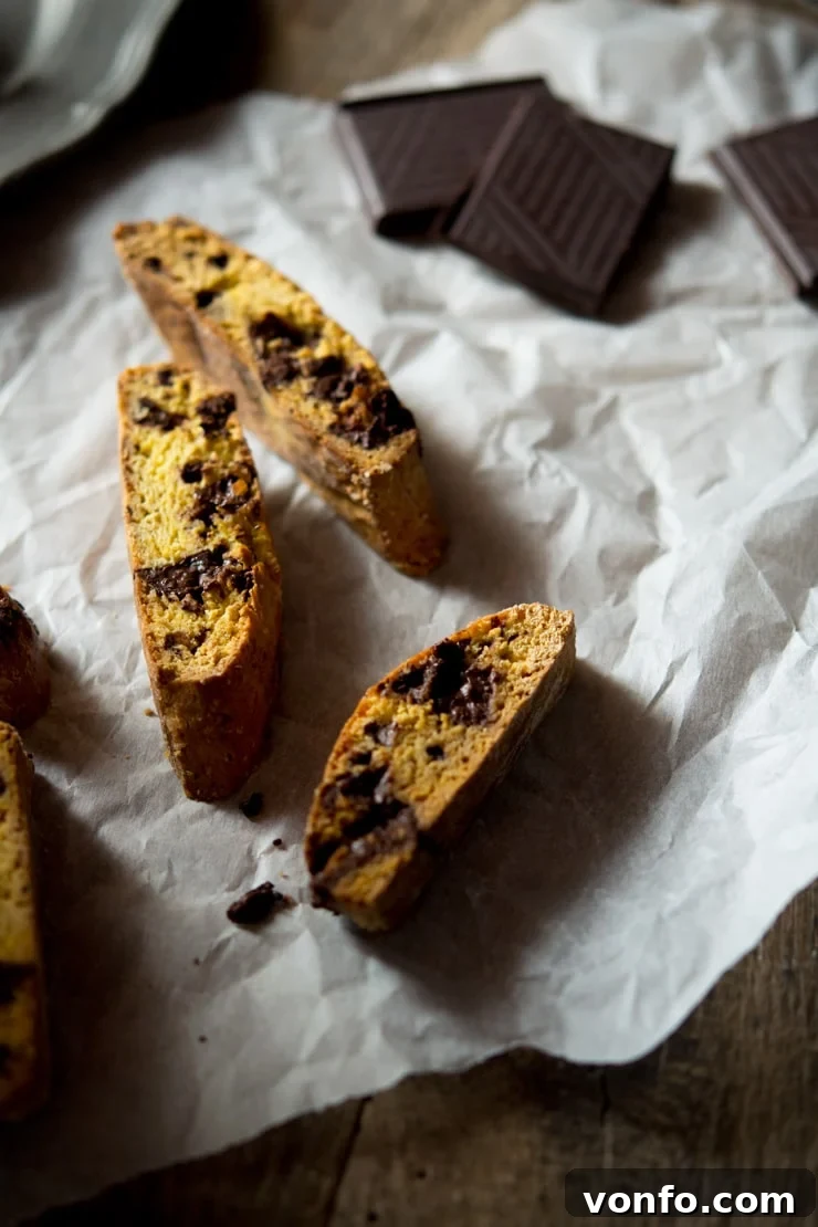 Homemade Orange Chocolate Cantucci biscuits cooling on a wire rack, showcasing their golden-brown exterior and readiness for the second bake.
