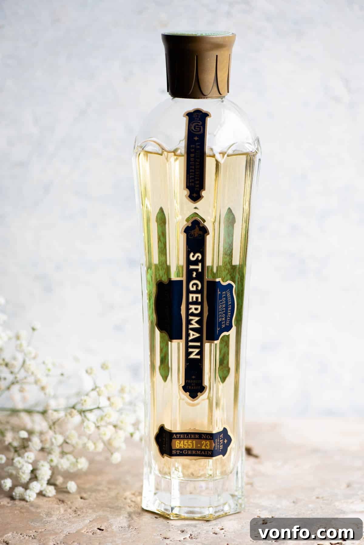 Elderbloom Sparkler 3 A close up of a beautiful bottle of St Germain elderflower liqueur, highlighted for its essential role in a Hugo Spritz.