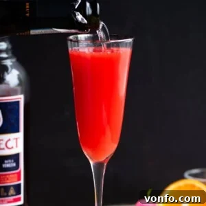 A close-up cropped image of a Select Mimosa with a black background, showcasing the drink's color and clarity.