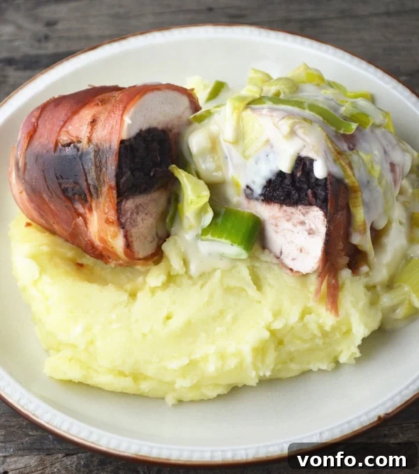 Black Pudding Stuffed Chicken with Cheesy Leeks, beautifully plated and ready to be served with creamy mashed potatoes