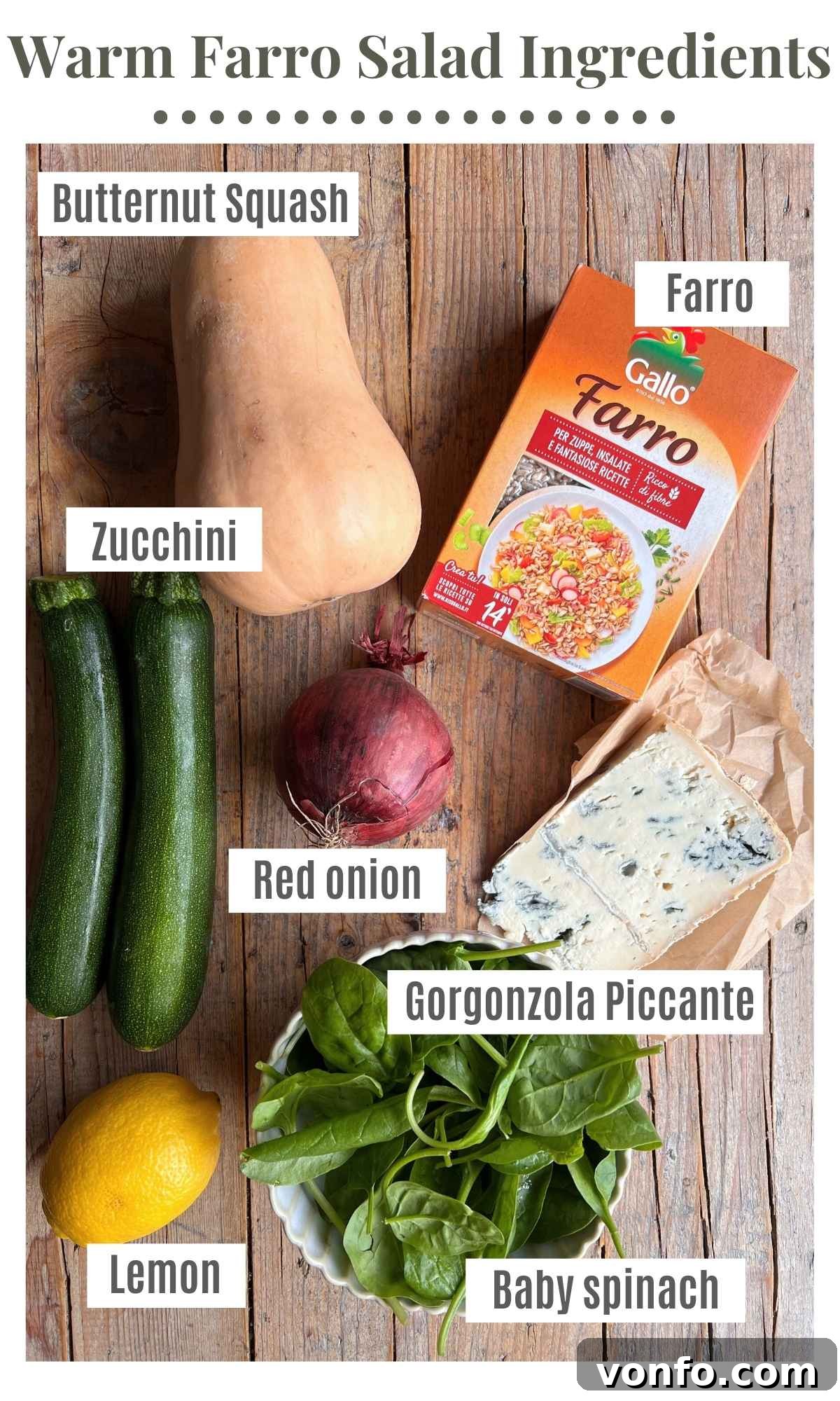 An overhead shot of all the fresh ingredients needed to make a warm farro salad with butternut squash, artfully arranged on a rustic table.