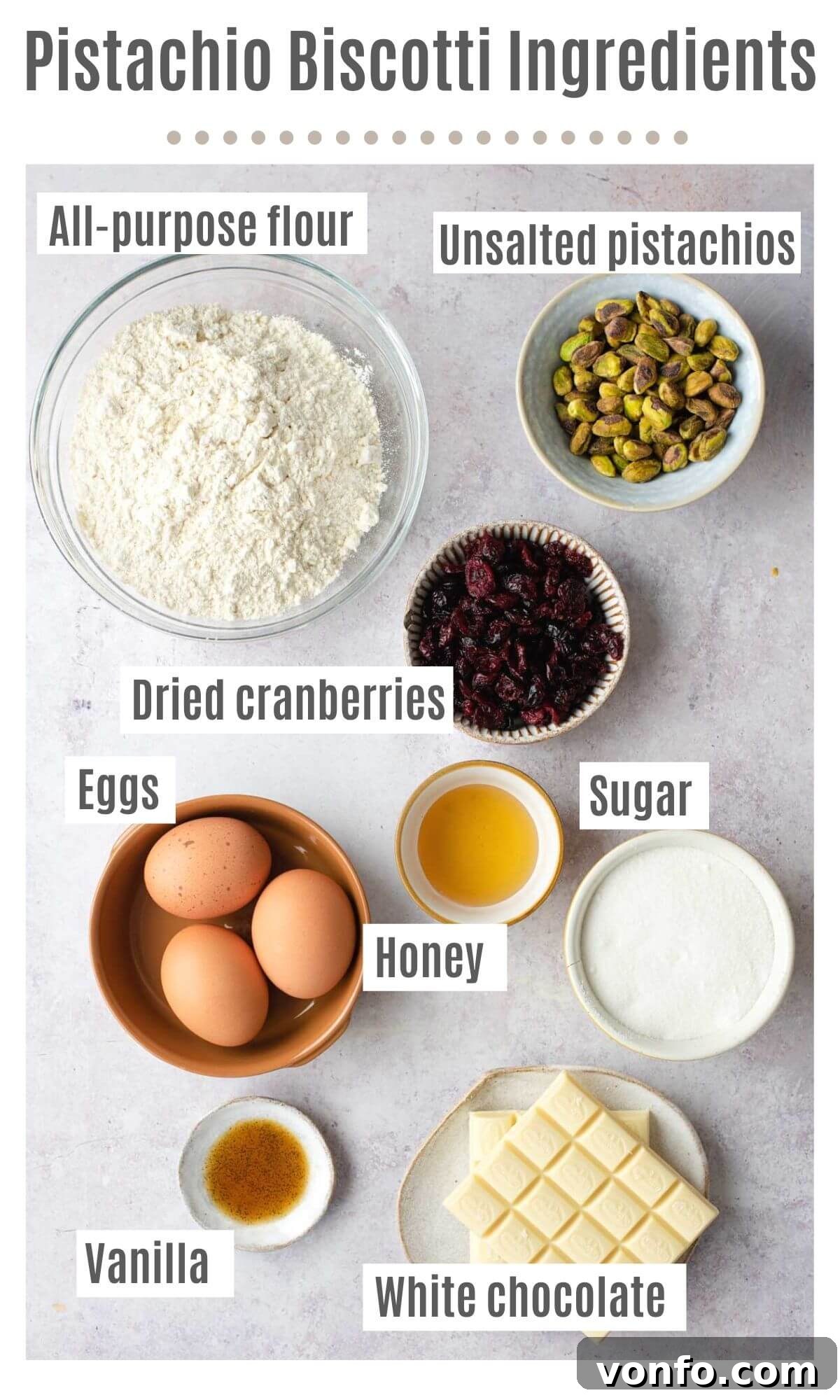 An overhead shot showcasing all the essential ingredients for making cranberry and pistachio biscotti, neatly arranged and ready for preparation.