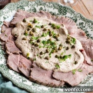 A cropped image of vitello tonnato on a serving platter.