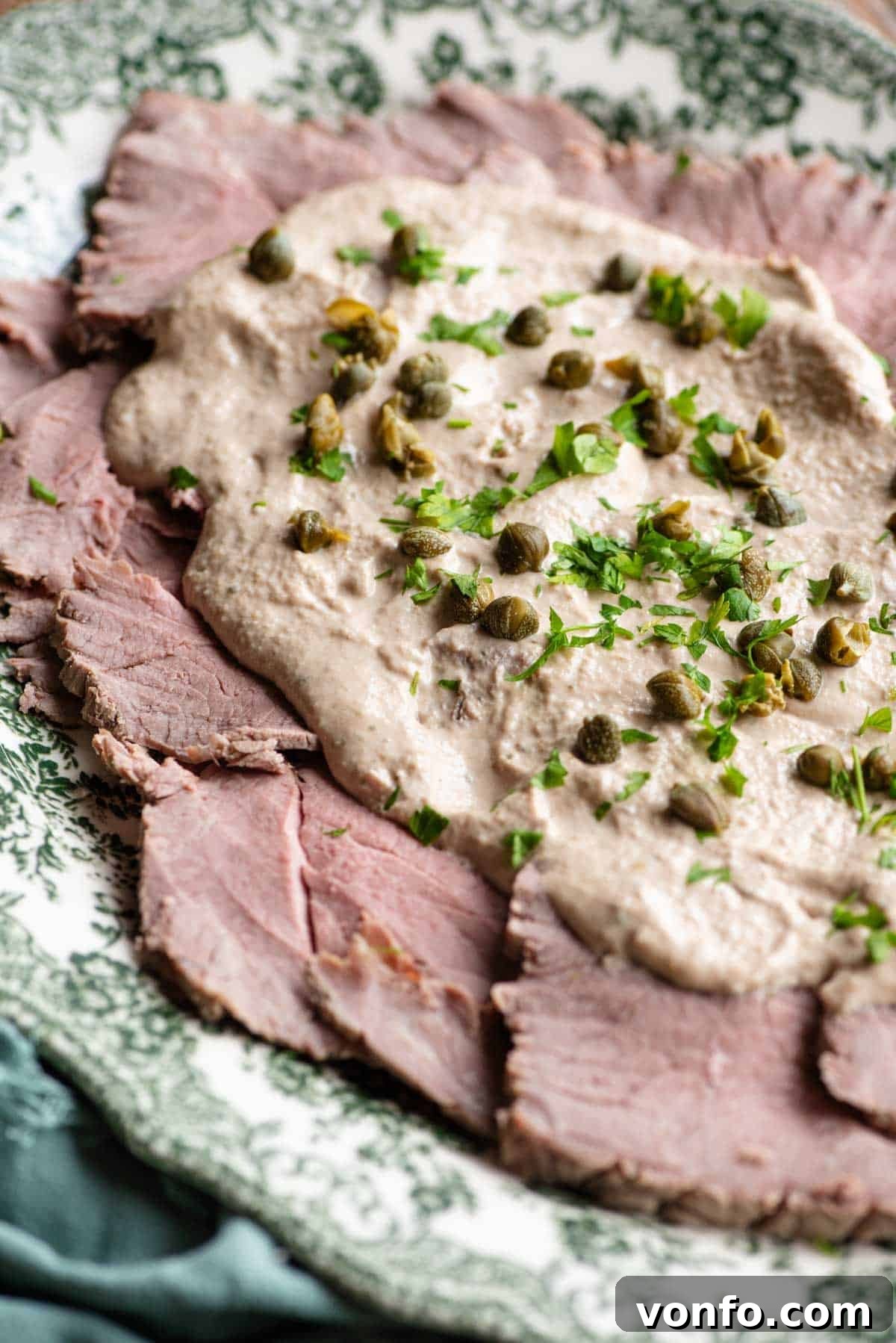 A close up of Vitello Tonnato on a serving dish.