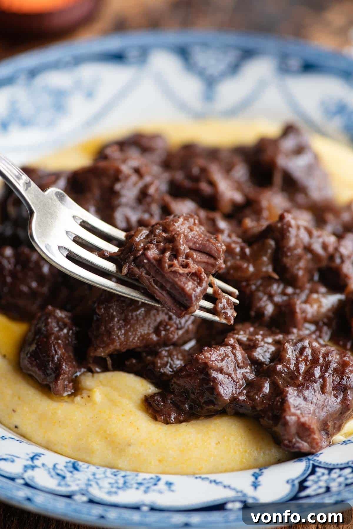 Carbonade Valdostana: Hearty Red Wine Beef Stew with Aromatic Spices 7 A close-up shot of the tender Italian beef stew on a fork, highlighting its rich texture and appetizing appearance.