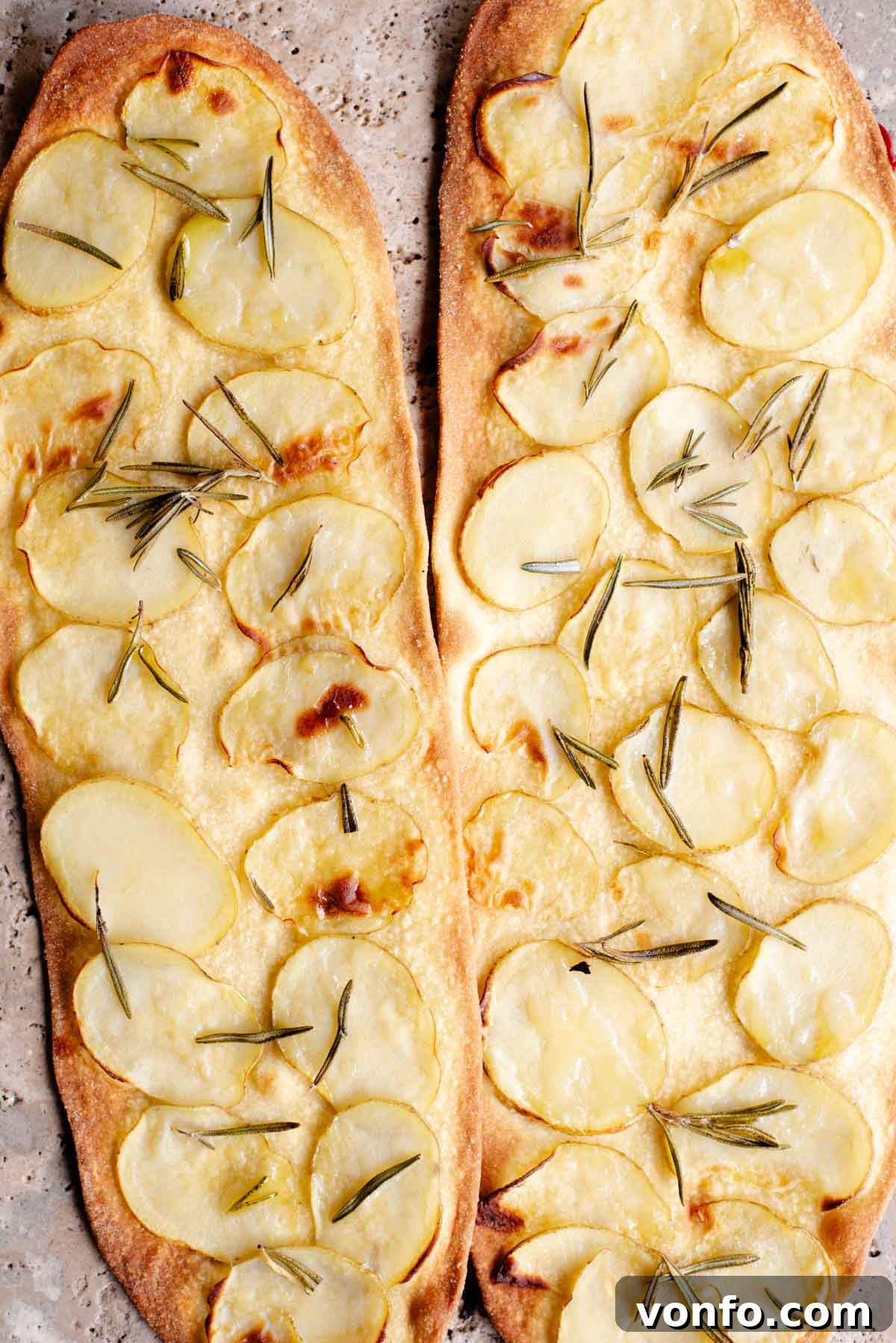 Fast & Crispy Pizza Fingers 8 Two long and thin pizzas with slices of potato and rosemary on top.