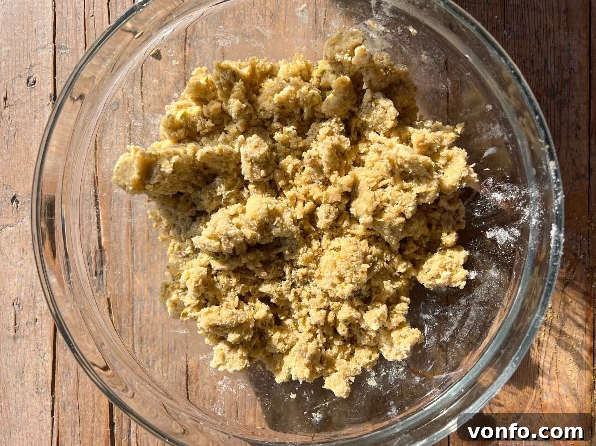 Rustic Italian Pistachio Crumb Cake 8 Pastry dough for Sbrisolona showing a rough crumb texture in a clear glass bowl, after butter and egg have been incorporated.