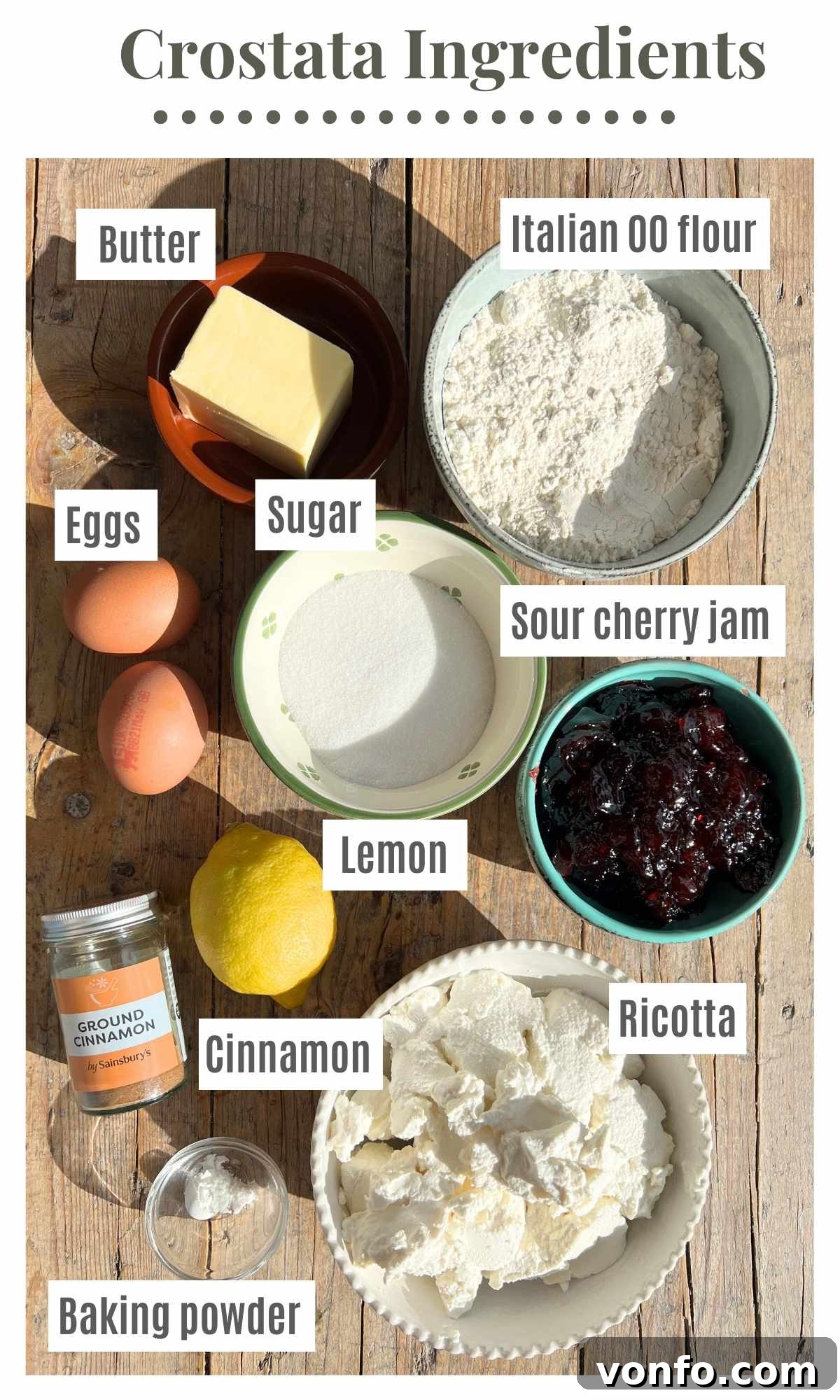 All the essential ingredients for making Crostata Ricotta e Visciole carefully arranged on a rustic wooden surface, ready for baking.