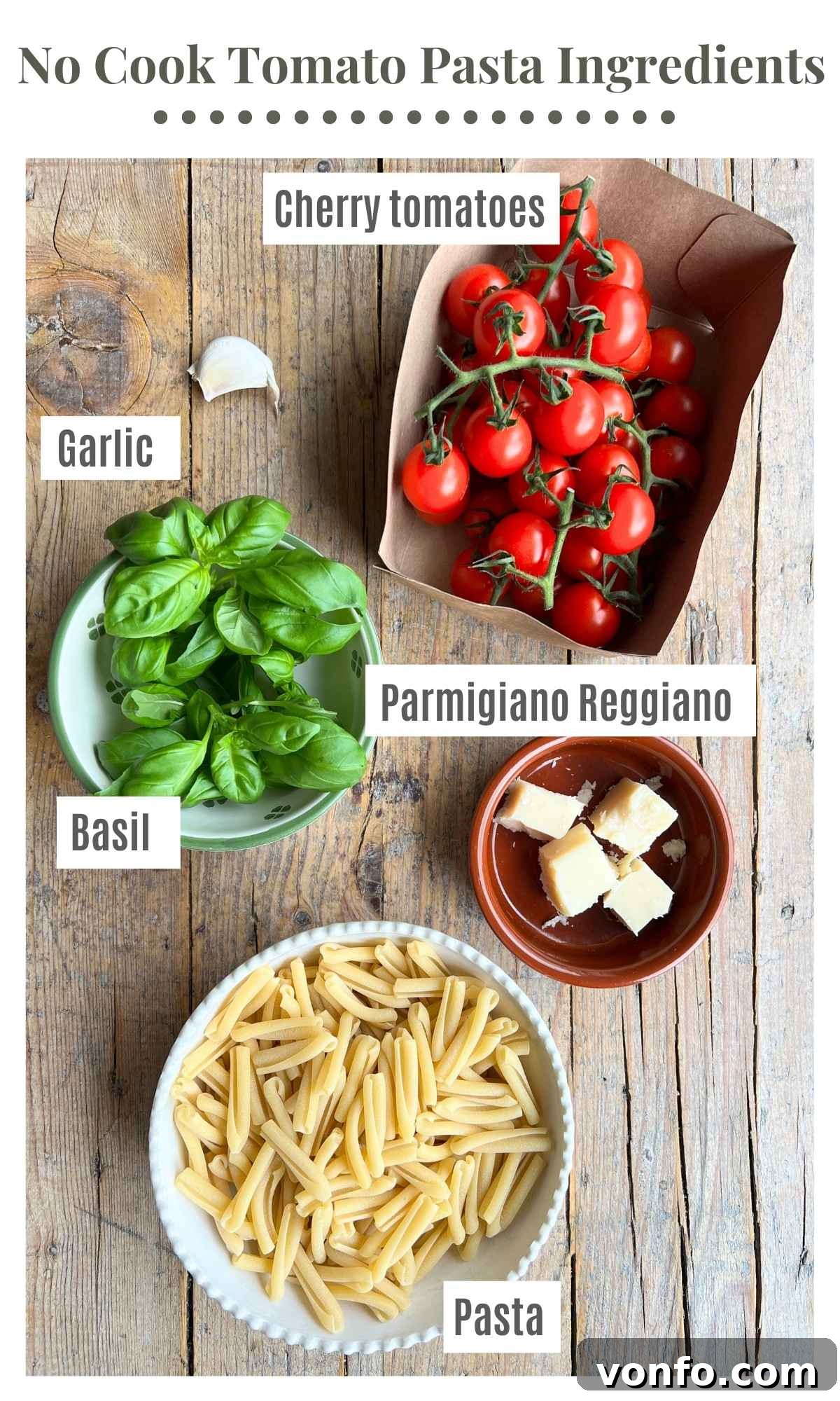 Effortless Fresh Tomato Pasta Sauce 3 All the fresh ingredients for making a no-cook tomato pasta sauce laid out on a rustic wooden surface: vibrant cherry tomatoes, uncooked short pasta, garlic cloves, a wedge of Parmigiano Reggiano cheese, and a generous bunch of fresh basil.