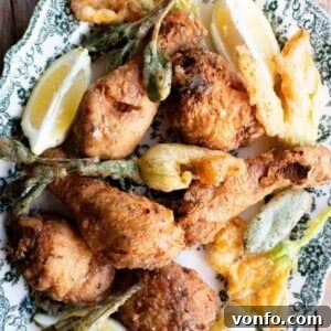 A close-up shot of golden-brown fried chicken pieces arranged on a serving platter, highlighting their crispy texture and delicious appeal.