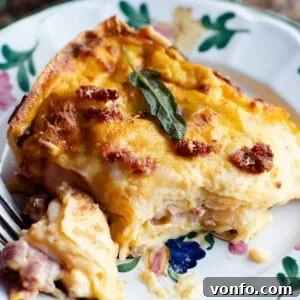 Butternut Squash Lasagna with Sausage and Taleggio, a close-up of a generous slice.
