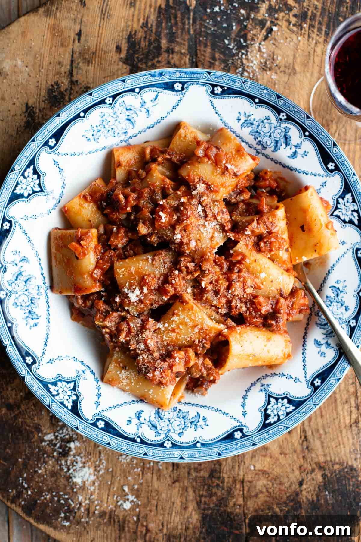 Piedmontese Hazelnut Ragu: A Rustic Italian Delight 2 A beautiful blue and white vintage style bowl filled with paccheri pasta generously coated in a rich hazelnut ragu, garnished with fresh herbs, ready to be enjoyed.
