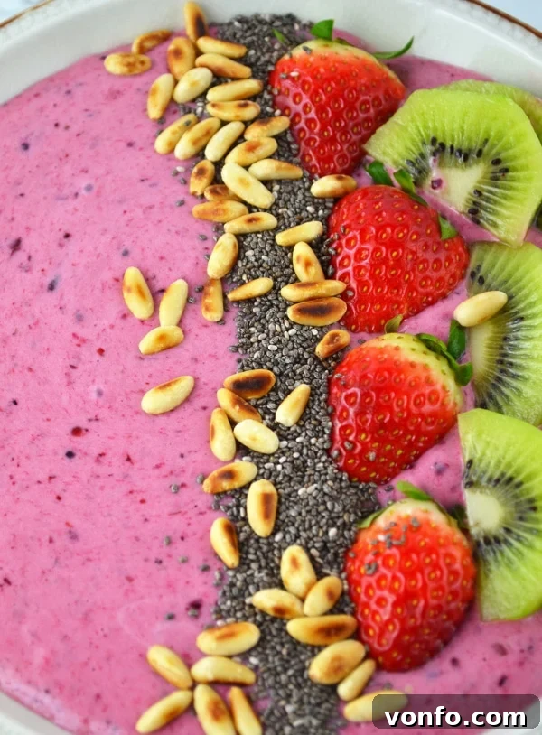 Berry Banana Smoothie Bowl from an aerial view with a spoon, ready to eat