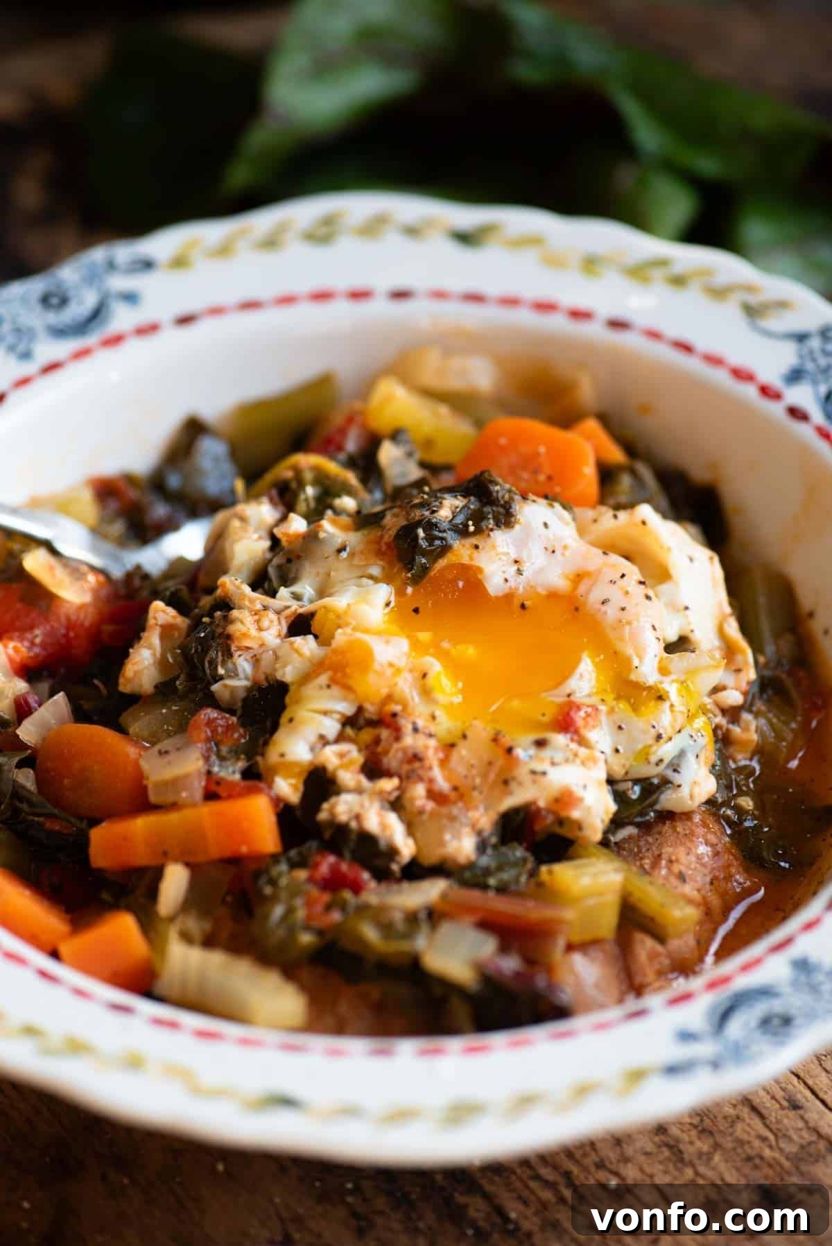 Acquacotta: The Rustic Tuscan Soup Crowned with Poached Eggs 4 A close up of a Tuscan vegetable soup (Acquacotta) in a bowl topped with a poached egg, showing the texture and vibrant colors.