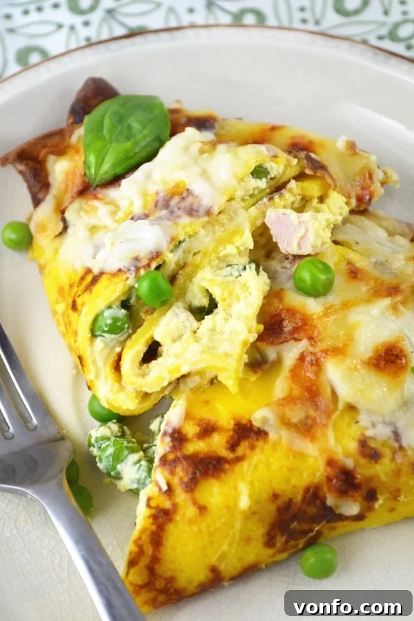 Cheesy Savory Crespelle Fresh from the Oven Close-up of golden-brown Crespelle (savory crepes) baked with a rich cheese sauce.