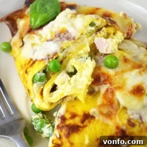 Final dish of Crespelle with Fontina cheese sauce, garnished with herbs.