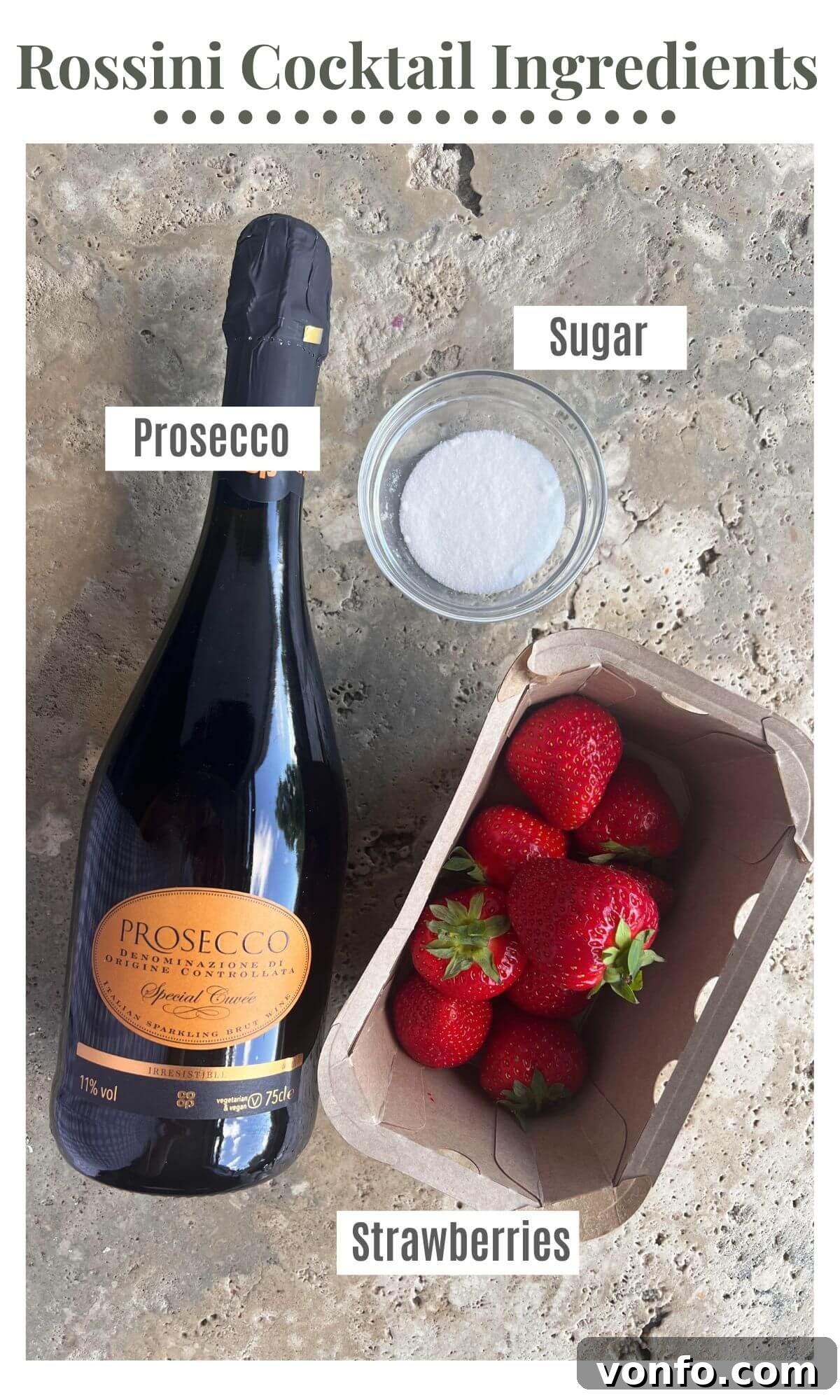 Strawberry Blush Sparkler 3 An overhead shot showcasing the core ingredients for a Rossini Cocktail: a bottle of crisp Prosecco, a punnet of ripe red strawberries, and a small bowl of white sugar, arranged on a rustic surface.