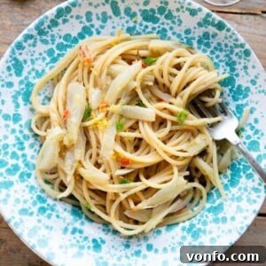 A cropped square image of roasted fennel pasta in a blue bowl.