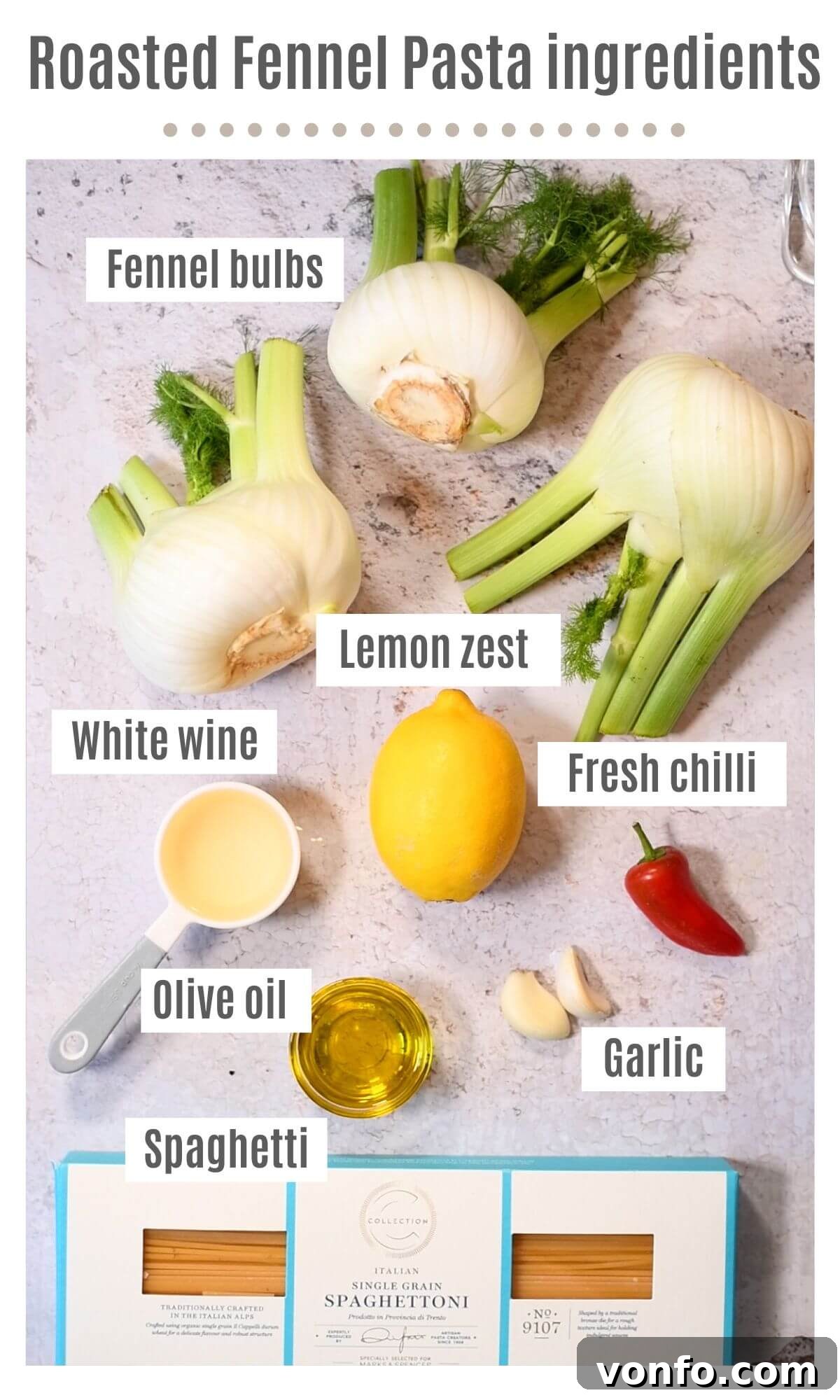 An overhead shot of all the ingredients needed to make roasted fennel pasta, including spaghetti, fennel bulbs, garlic, chili, wine, lemon, and olive oil.