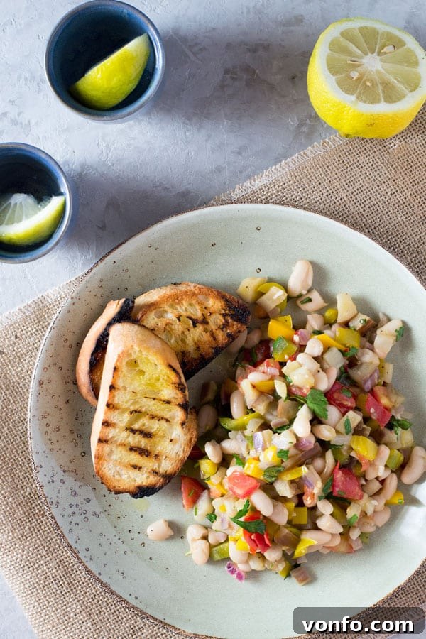 Warm easy bean salad with eggplant, tomato, garlic and fresh herbs. A simple and delicious summer recipe from Insidetherustickitchen.com