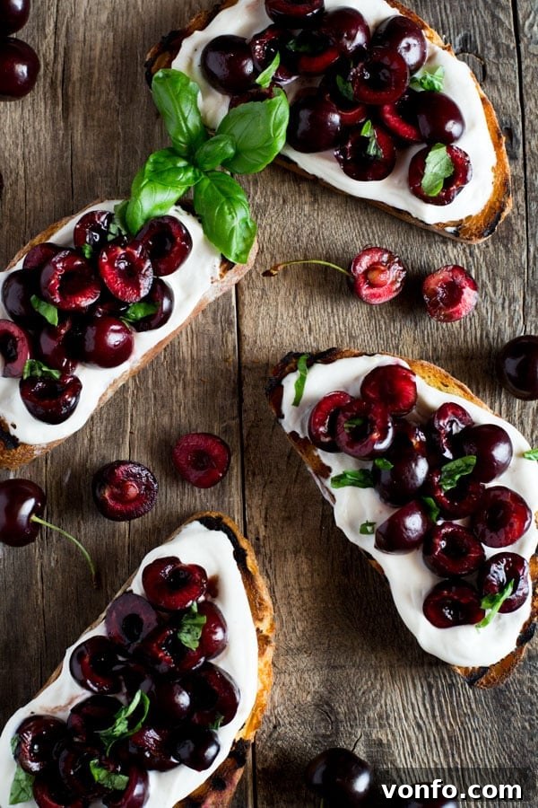Balsamic Cherry Ricotta Toast 3 Whipped ricotta toast with balsamic cherries on a wooden board inside a rustic kitchen