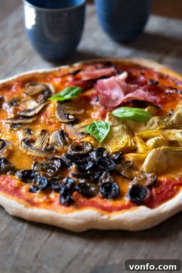 Close-up of baked Quattro Stagioni pizza showing crispy crust and melted cheese
