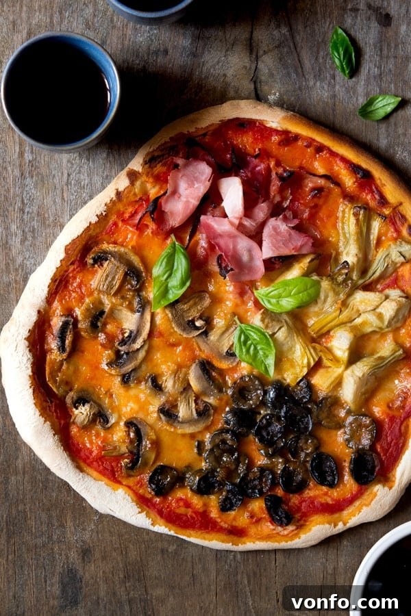 Freshly prepared Quattro Stagioni pizza before baking, showcasing toppings arrangement