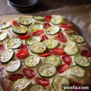 Rustic Zucchini Tomato Focaccia 2 Prepared Zucchini Tomato Focaccia ready for baking, showcasing its fresh ingredients.