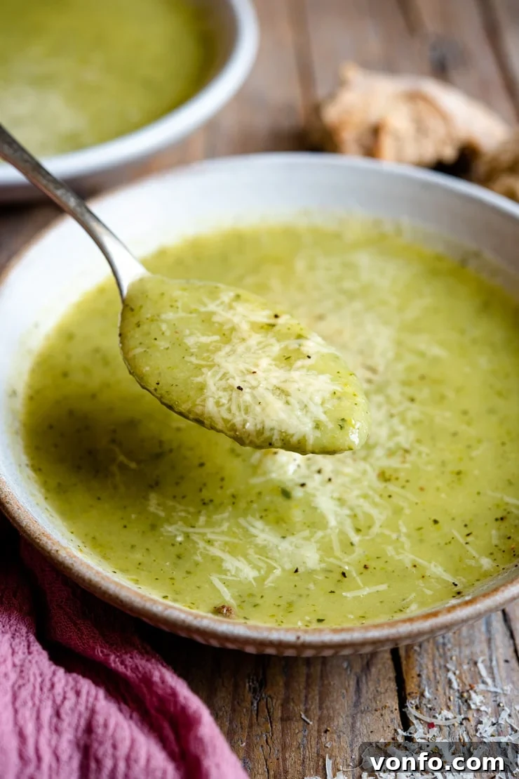 Creamy Italian Potato and Zucchini Soup - An easy soup that's comforting, warming and packed full of flavour. Healthy, delicious and easy comfort food the whole family will love. #zucchini #soup #comfortfood A close up of a spoonful of creamy zucchini soup