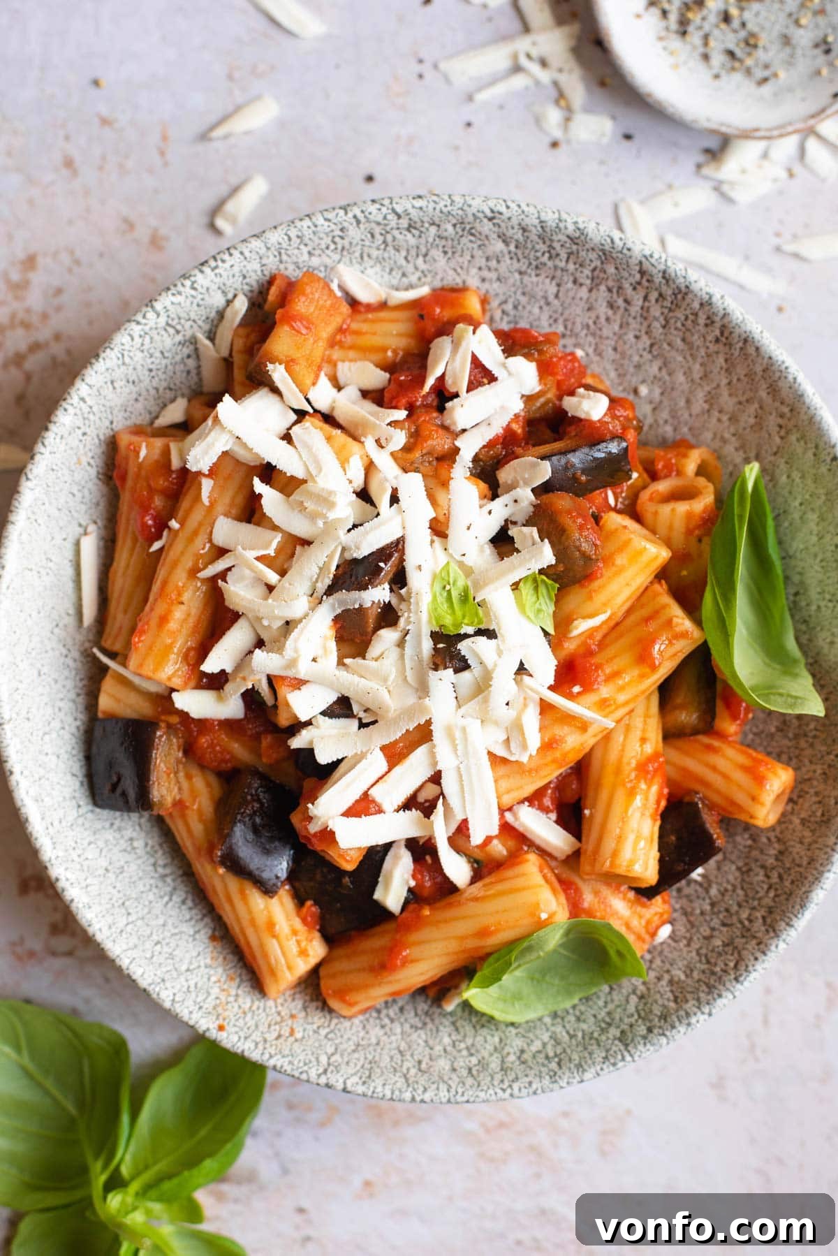 Classic Sicilian Eggplant Pasta 2 An overhead shot of Pasta alla Norma in a bowl topped with cheese