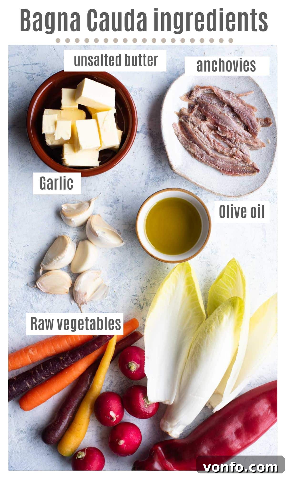 Bagna Cauda: The Ultimate Warm Garlic and Anchovy Butter 3 An overhead shot showcasing all the fresh, high-quality ingredients required to prepare a traditional Bagna Cauda: olive oil, fresh garlic cloves, anchovy fillets, and unsalted butter.
