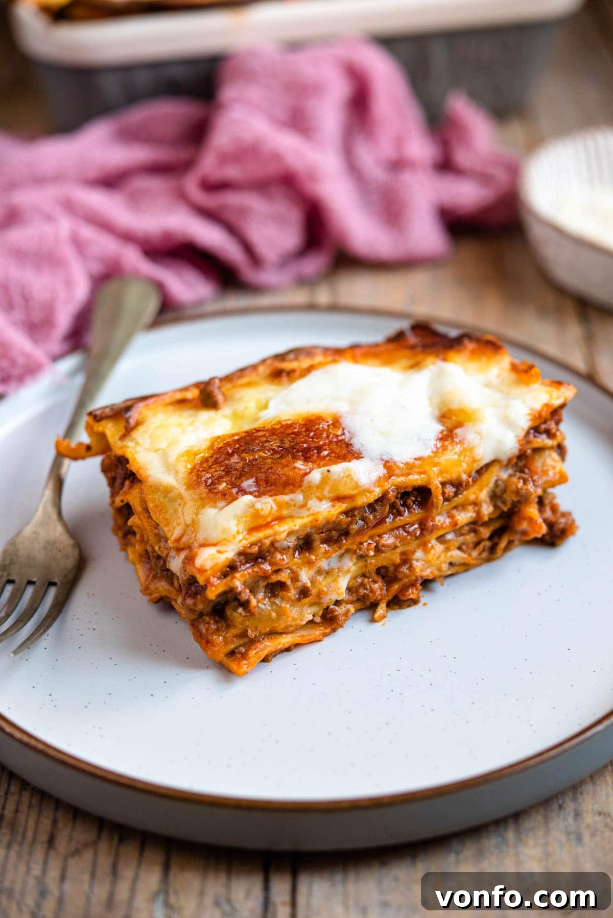A perfectly portioned slice of beef lasagna on a plate, ready to be enjoyed