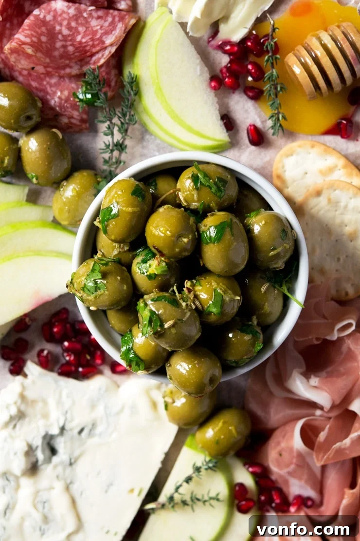 Close-up of Freshly Marinated Olives with Herbs and Spices A close-up shot of vibrant marinated olives glistening in a ramekin