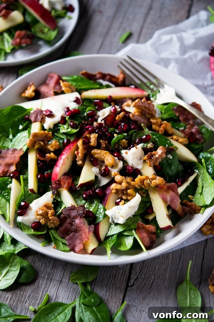 Winter Salad on a Wooden Surface A beautifully composed winter salad served on a large white plate, ready to be enjoyed