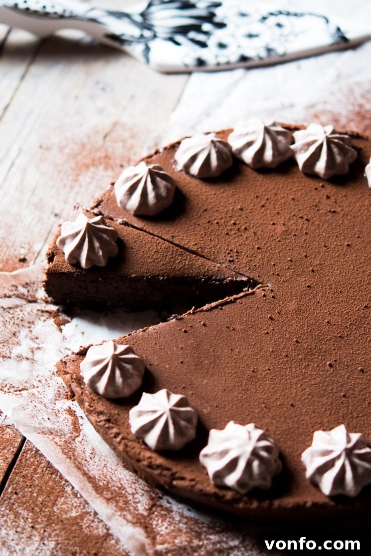 A perfectly cut slice of no-bake chocolate cheesecake resting on a wooden surface, showcasing its distinct layers and rich texture.