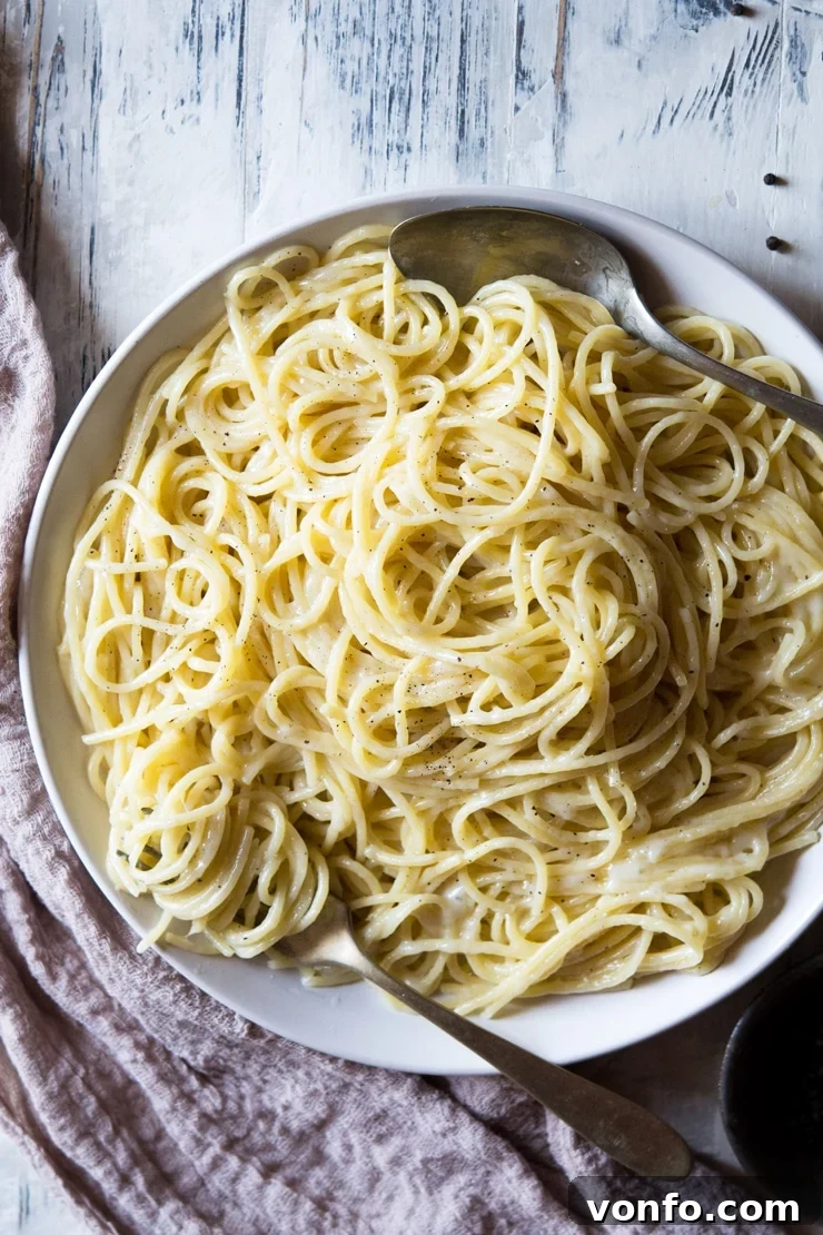 An overhead shot of cacio e pepe recipe in a plate with a fork An overhead shot of cacio e pepe recipe in a plate with a fork